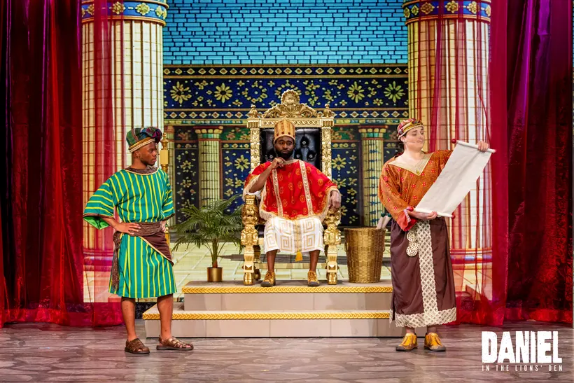 King Darius on his throne as an advisor presents a scroll