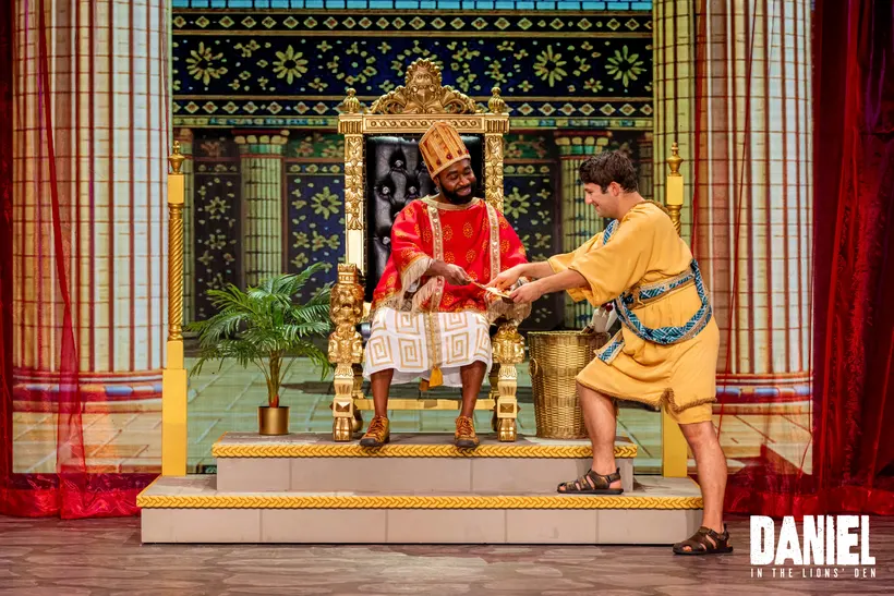 King Darius greets Daniel at the foot of the throne